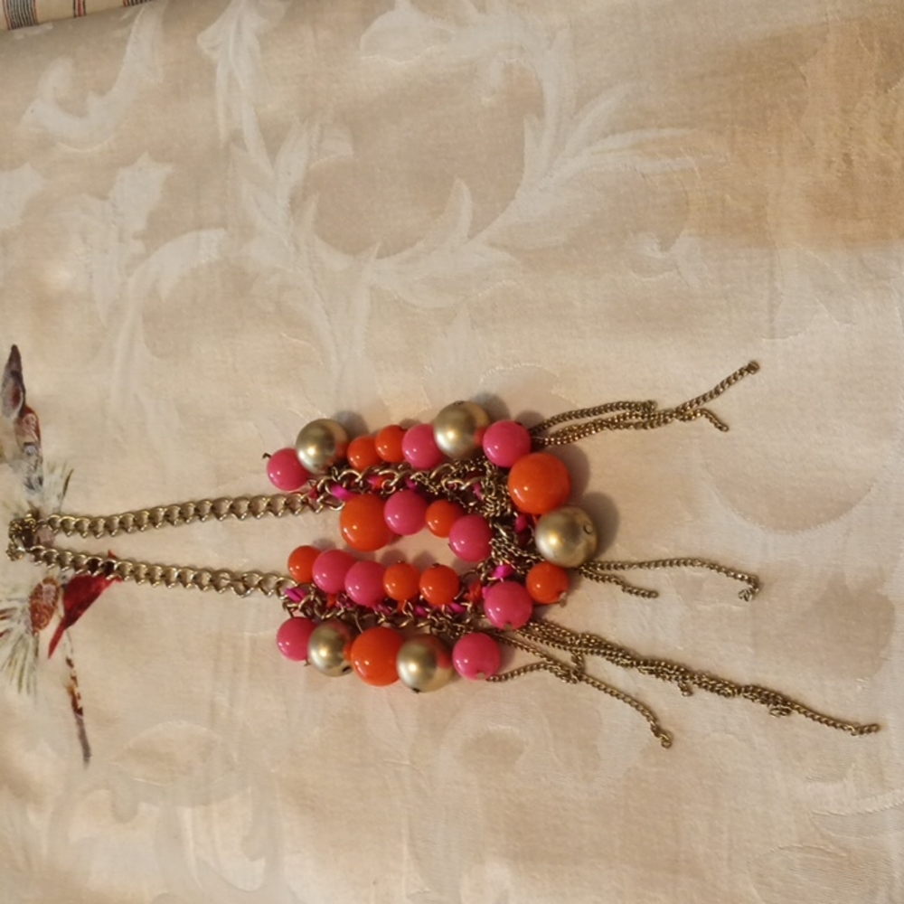 Women's gold tone necklace with gold and pink varying size beads. Used.